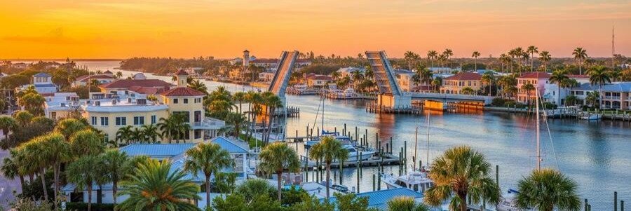 Warm orange sunset light reflecting off the calm harbor water and small fishing boats in Salerno.
