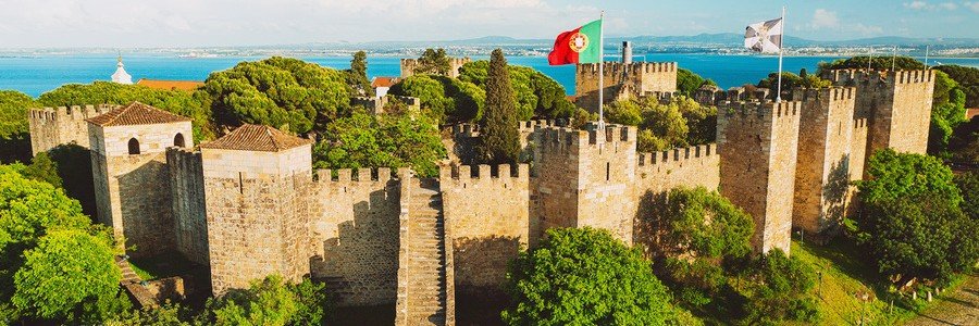 São Jorge Castle walls with Portuguese flag overlooking Lisbon and the river