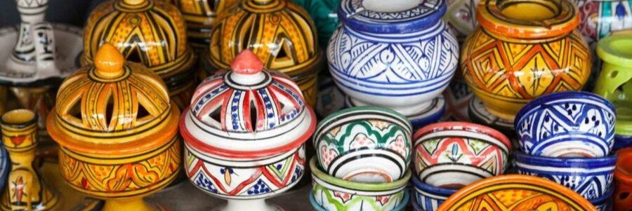 Colorful Moroccan ceramic pottery and souvenirs in Tangier market.