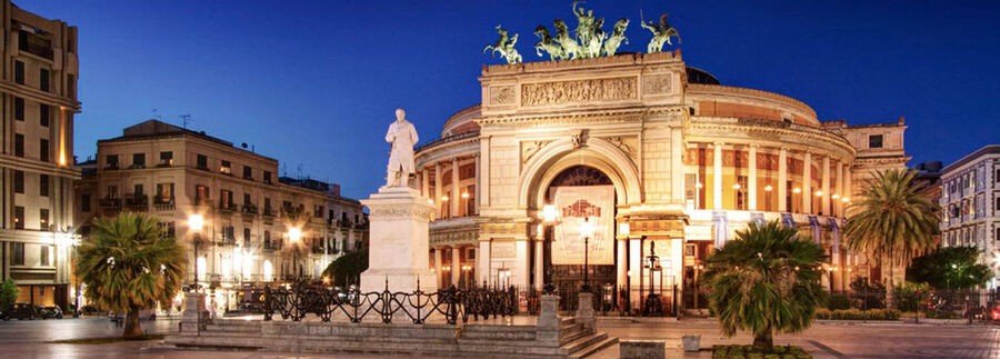 Teatro Politeama in Palermo at night with illuminated architecture and surrounding square