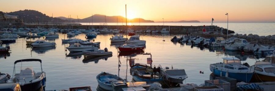 Toulon harbor at sunset with boats and calm Mediterranean water