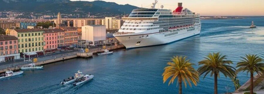 Cruise ship docked at Toulon Port with colorful buildings and waterfront harbor