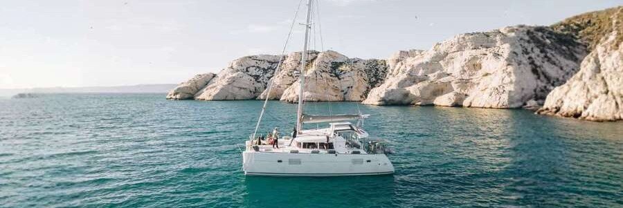 Boat tour near Toulon coastline with clear blue water and rocky cliffs