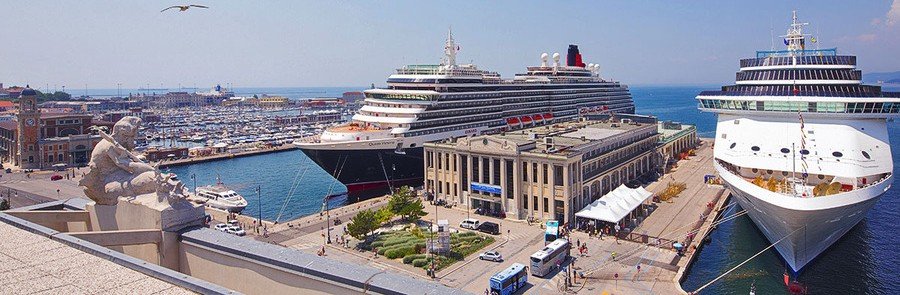 Sailboats gathered near lighthouse at Triets Port Trieste Italy on a clear blue day