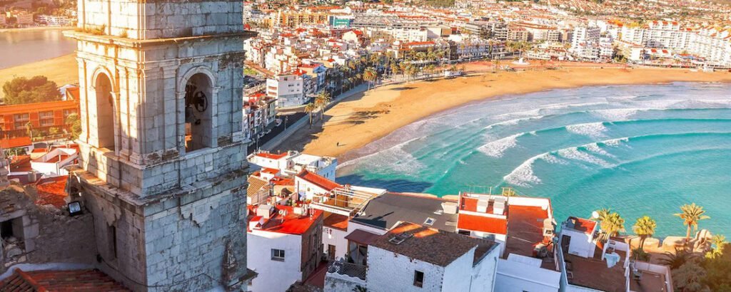 Valencia Port view in Spain with sandy beach, turquoise water, and coastal city skyline from a scenic viewpoint