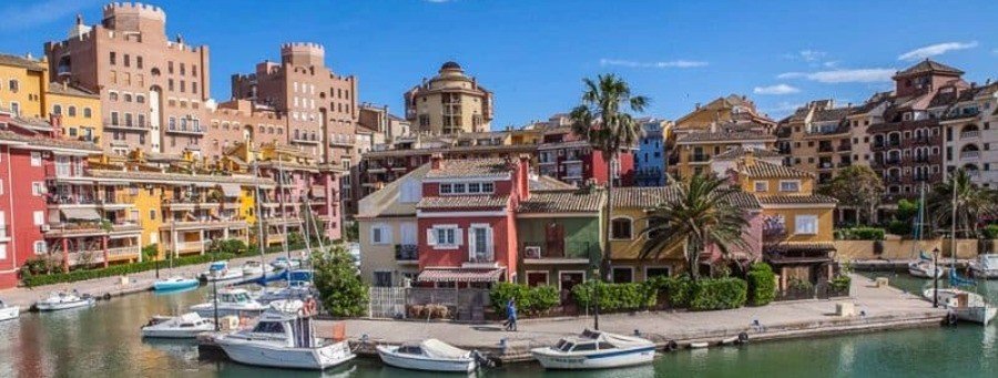 Colorful waterfront buildings and marina near Valencia port in Spain with boats and vibrant coastal architecture