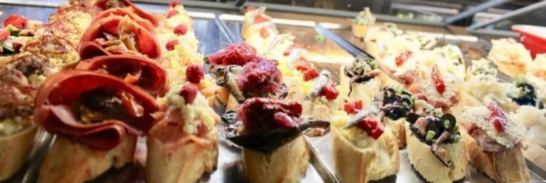 Traditional cicchetti snacks and small bites served inside a local Venice wine bar