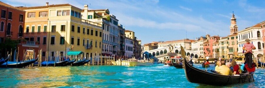 Gondola ride along the Grand Canal with historic buildings in Venice