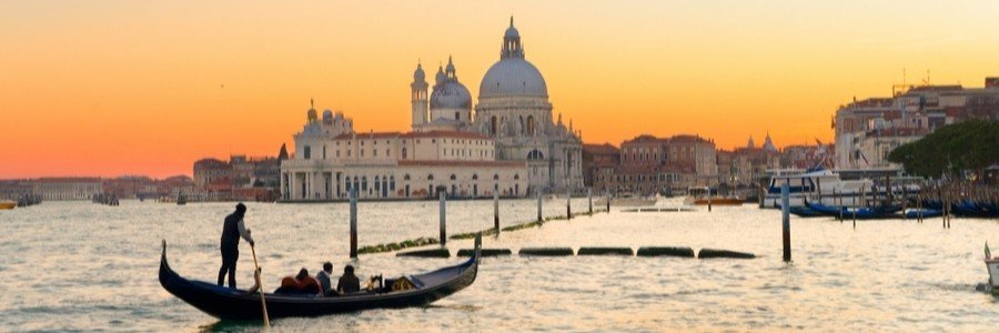 Gondola at sunset on the Grand Canal with warm golden light