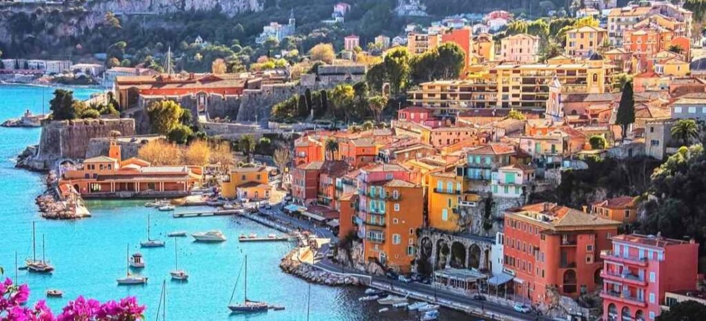 Colorful waterfront buildings and boats at Villefranche-sur-Mer harbor on the French Riviera