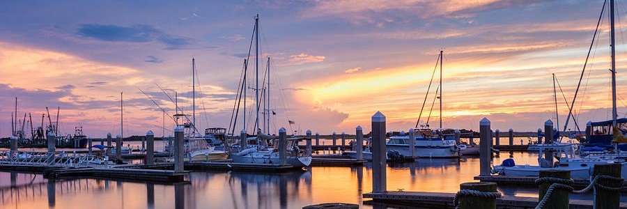 Sunset over Fernandina Harbor marina with sailboats and colorful skies on Amelia Island, Florida.