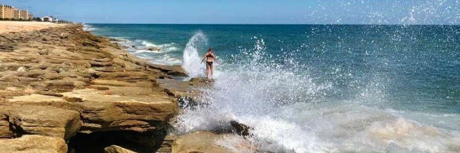 Waves crashing against coquina rock formations along Flagler Beach on Florida's Atlantic Coast.