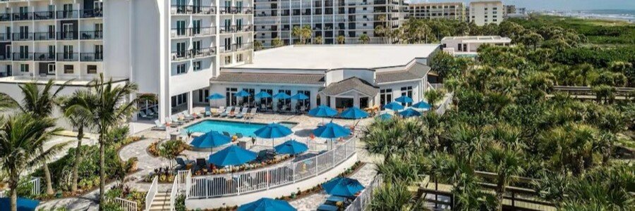 Outdoor pool and tropical pool deck at Hilton Garden Inn Cape Canaveral