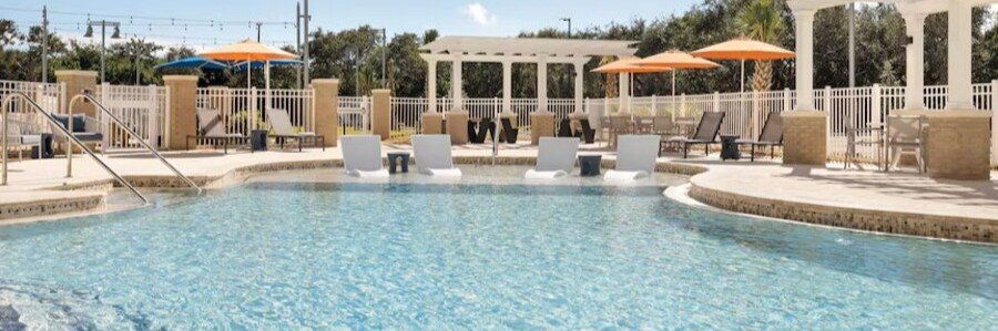 Outdoor swimming pool and lounge area at Holiday Inn Express Cape Canaveral near Port Canaveral.