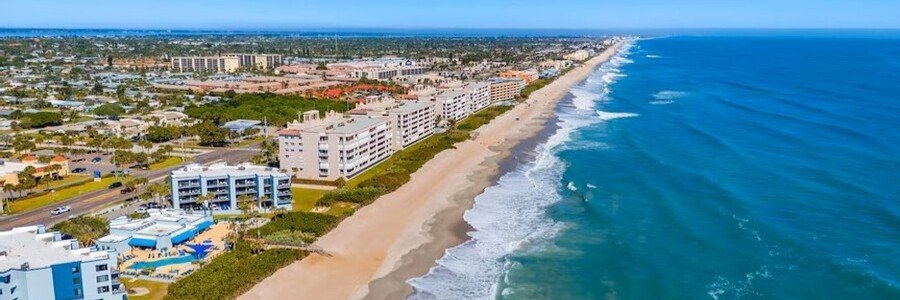 Aerial view of Indian Harbour Beach showing its long sandy coastline and Atlantic Ocean.