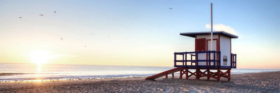 Indian Harbour Beach Lifeguard Station | Beach Travel Destinations Lifeguard station overlooking the beach at sunrise in Indian Harbour Beach, Florida.