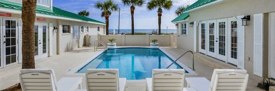 Pool area at Island Cottage Inn Adults Only near Flagler Beach with lounge chairs and ocean views.