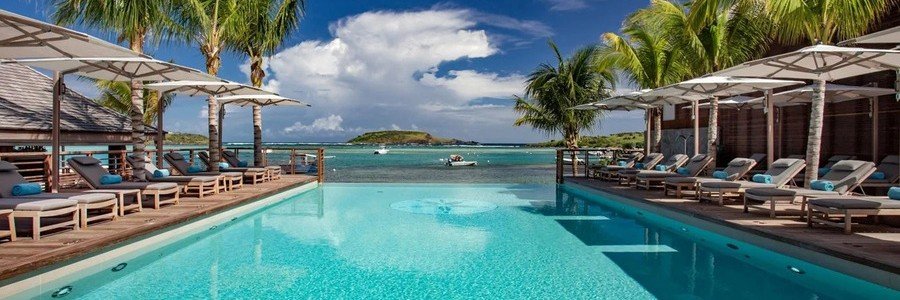 Beachfront pool at Le Barthélemy Hotel & Spa overlooking Grand Cul-de-Sac Lagoon.