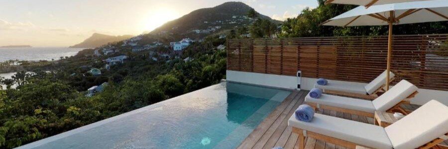 Infinity pool overlooking the hills and coastline at Le Toiny Hôtel & Beach Club in St. Barts.