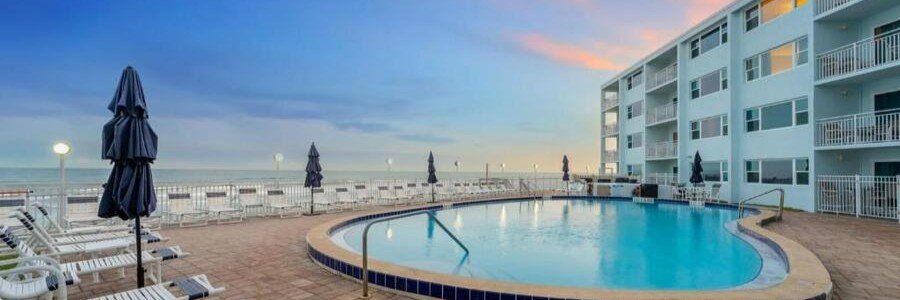 Oceanfront swimming pool at Paradise Beach Club overlooking the Atlantic Ocean in Florida.