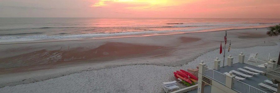 Early morning view of Ponte Vedra Beach with calm waves and oceanfront resort accommodations.