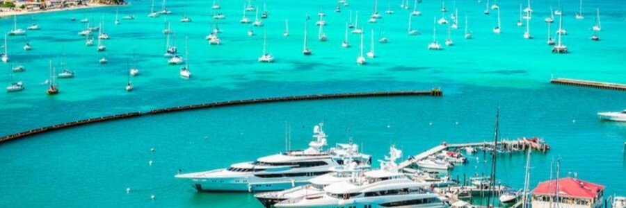 Luxury yachts anchored in the turquoise waters of St. Barts marina.