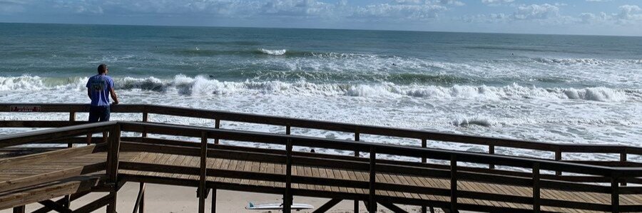 Wooden beach boardwalk overlooking waves and the Atlantic Ocean