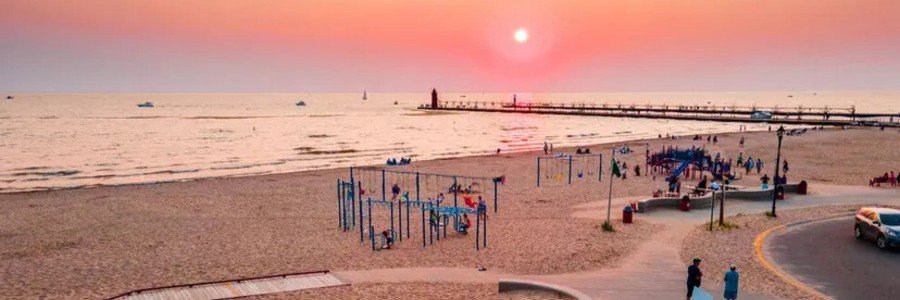 Sunset over a sandy beach and fishing pier along Florida's Space Coast