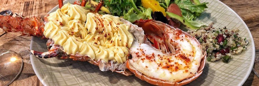 Fresh grilled lobster served with creamy potatoes and salad in St. Barts.