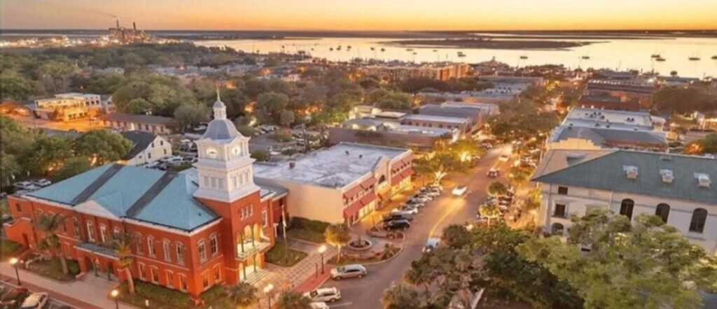 Aerial view of historic downtown Fernandina Beach at sunset showing the courthouse clock tower and Center Street.