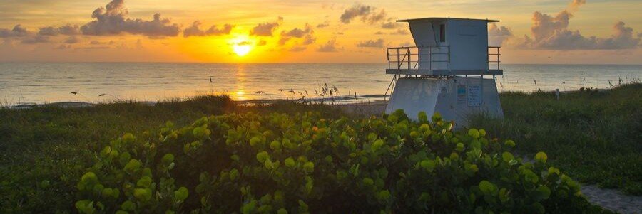 Sunrise over Hobe Sound Beach with a lifeguard tower along Florida's Atlantic coast.