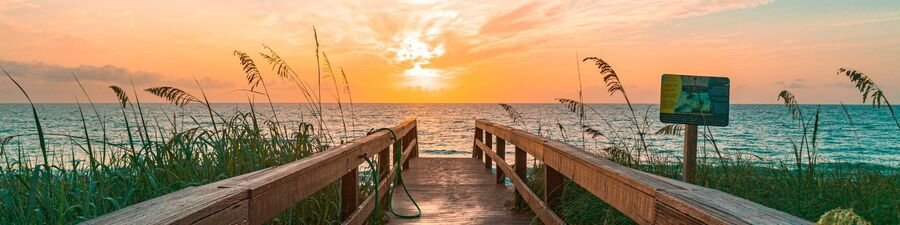 Beach boardwalk leading to the Atlantic Ocean at sunset on Hutchinson Island, Florida.