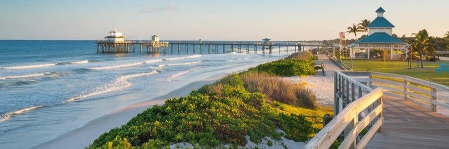 The boardwalk leading to Indialantic Beach with the Indialantic Pier stretching into the Atlantic Ocean on Florida's Space Coast.