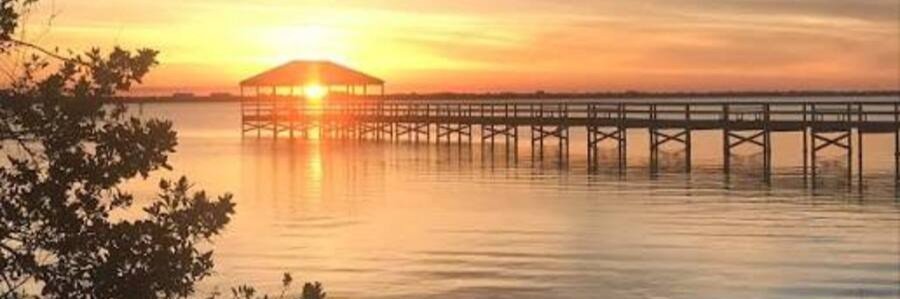 Sunset over a fishing pier on the Indian River near Indialantic, Florida.