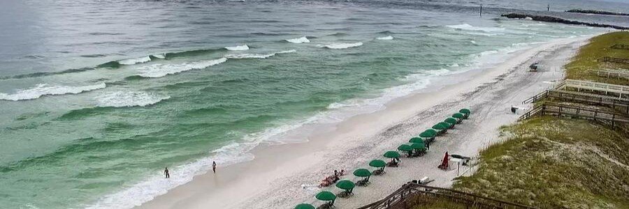 Wide sandy shoreline with gentle waves at Jensen Beach, Florida.