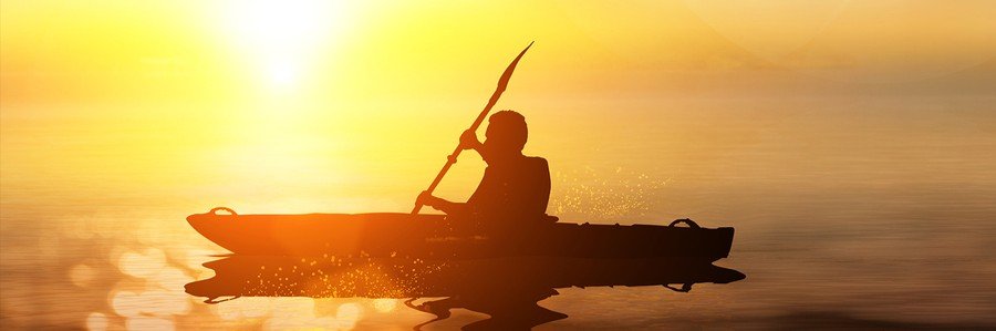 Sunset Kayaking in Merritt Island, Florida Person kayaking across calm water during a colorful sunset in Merritt Island, Florida.