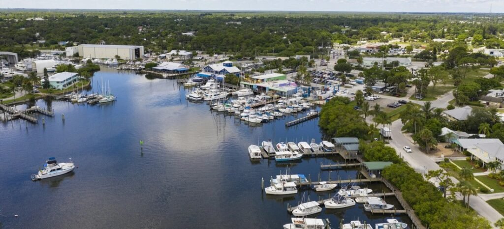 Aerial View of Port Salerno Marina | Beach Travel Destinations Aerial view of the marina and waterfront along Manatee Pocket in Port Salerno, Florida.