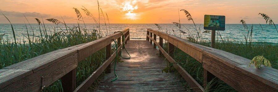 Beach boardwalk leading to the Atlantic Ocean near Port St. Lucie, Florida, at sunrise.