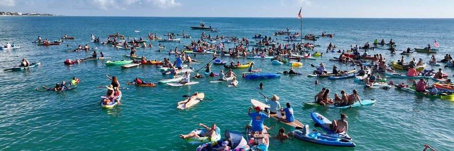 Paddling and Swimming Near Sebastian | Beach Travel Destinations Swimmers, kayakers, and paddleboarders enjoying clear coastal water near Sebastian