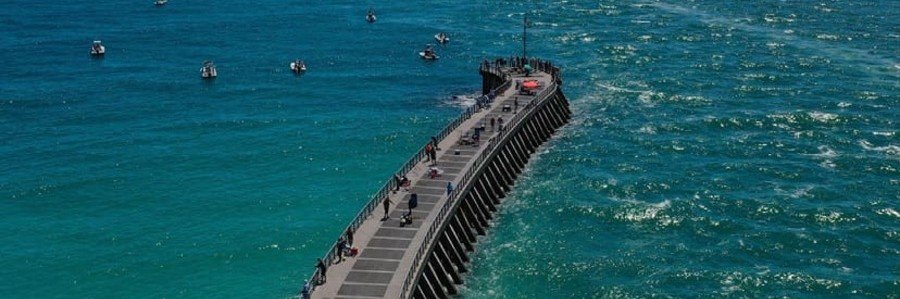 Fishing From the Sebastian Inlet Jetty | Beach Travel Destinations Aerial view of anglers fishing from the long jetty at Sebastian Inlet