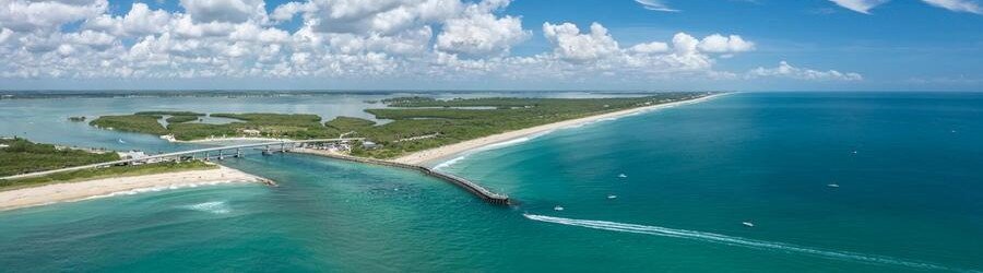 Sebastian Inlet and Indian River Lagoon | Beach Travel Destinations Aerial view of Sebastian Inlet between the Indian River Lagoon and Atlantic Ocean