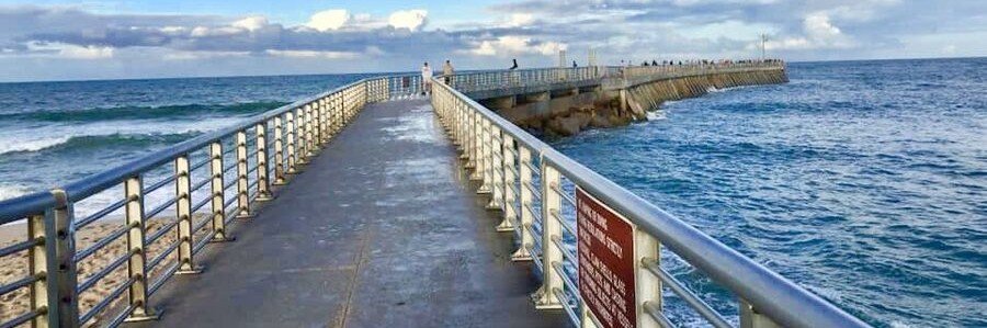 Fishing pier and jetty extending into the Atlantic Ocean at Sebastian Inlet State Park, Florida.