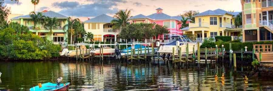 Colorful waterfront homes and private docks along a canal in Stuart, Florida.