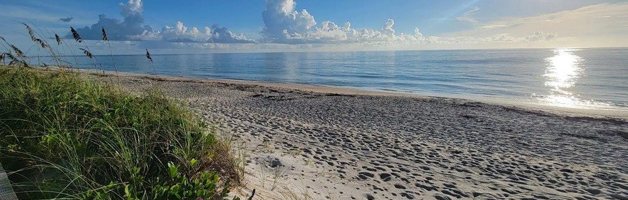 Sunrise over Tracking Station Beach in Indian River Shores, Florida, with sea oats and a quiet sandy shoreline.