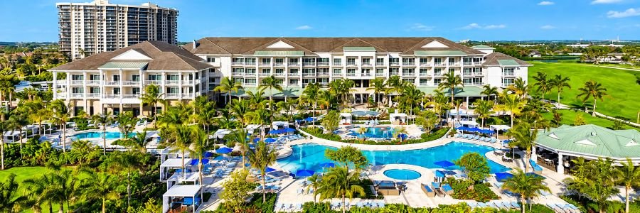 The Belgrove Resort & Spa in West Palm Beach with tropical pools, palm trees, cabanas, and lush resort grounds.