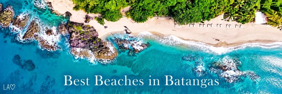 Best Beaches in Batangas | Beautiful Tropical Coastline Aerial view of a beautiful Batangas beach with turquoise waters, rocky formations, white sand, and lush tropical greenery.