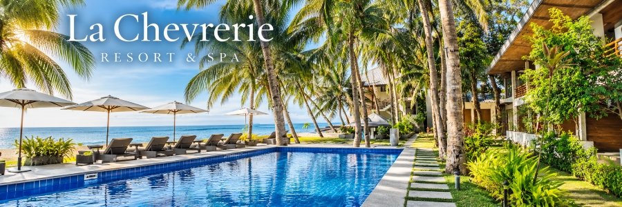 La Chevrerie Resort & Spa | Tropical Oceanfront Retreat Sparkling blue swimming pool surrounded by tropical palm trees, shaded lounge chairs, lush gardens, and beautiful ocean views at La Chevrerie Resort & Spa.