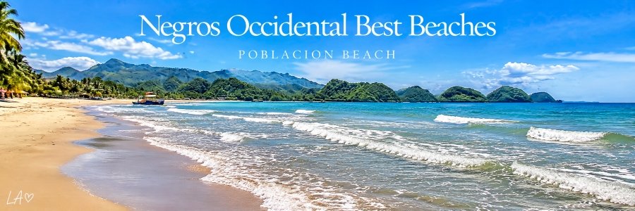 Golden sandy shoreline with gentle turquoise waves, lush green mountains, tropical palm trees, and a small fishing boat beneath a bright blue sky.